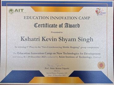 Two men in bicycle jerseys sitting outside at table having coffee