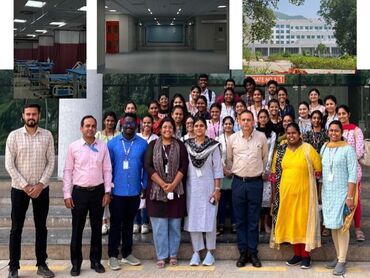 Two men in bicycle jerseys sitting outside at table having coffee