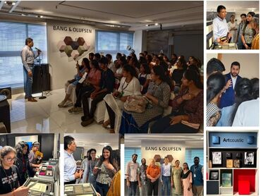 Two men in bicycle jerseys sitting outside at table having coffee